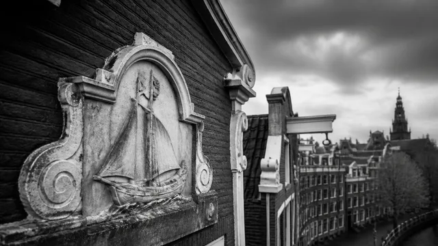 Historic brick building facade with "GABLE STONES" storefront sign and ornate "1734" address plaque above a black doorway…
