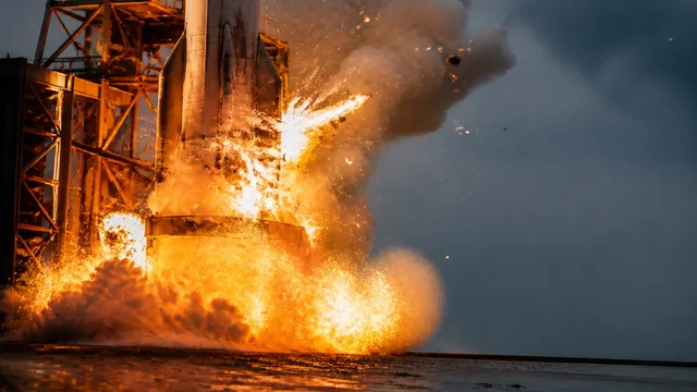 A massive nuclear-style explosion with bright yellow and orange fireball against a dark red sky, with white text reading…