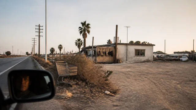 Abandoned desert highway at dusk with vintage gas station and "DON'T STOP" warning text overlaid on a desolate California…