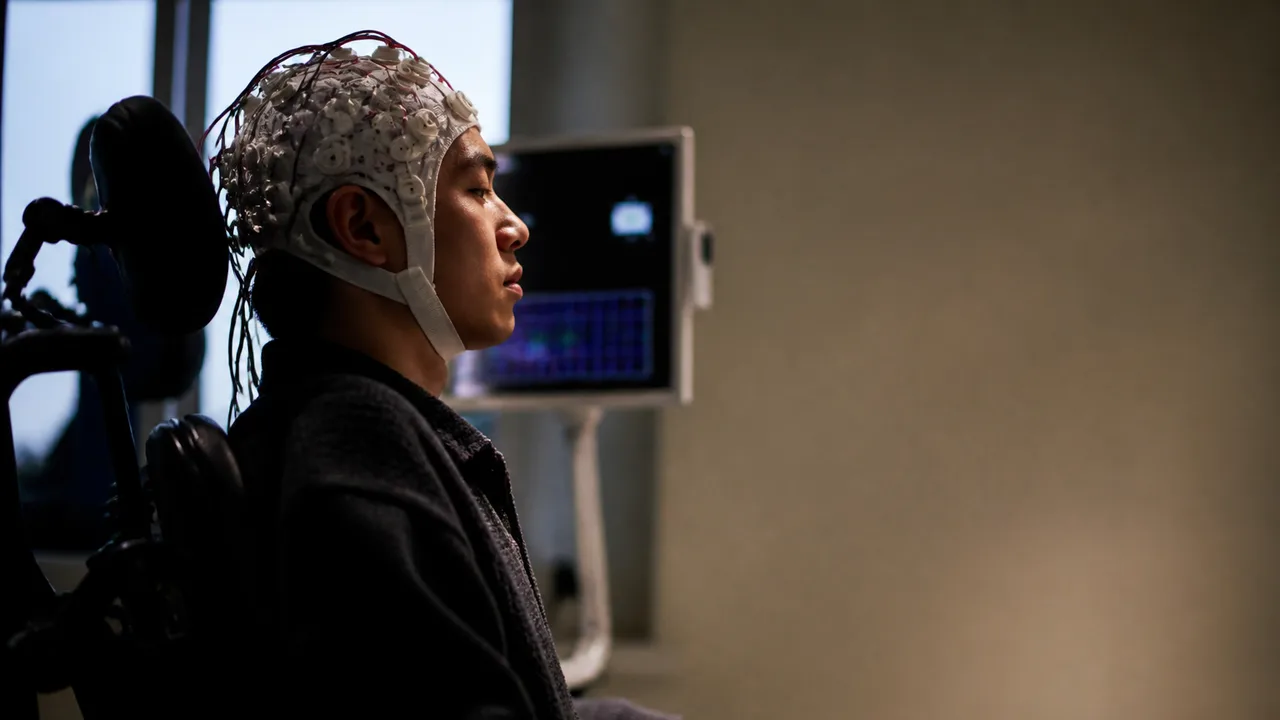 A translucent human head model in profile displays a computer chip implant, with "CONTROLLING COMPUTERS WITH BRAINS" text…