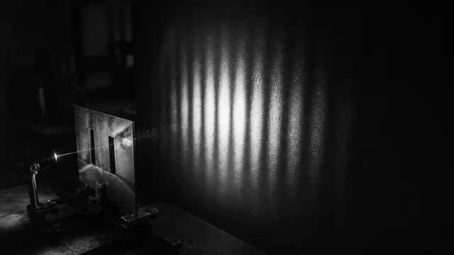 White text on a black background with blue particle effects forming vertical streams, displaying the video's main message…