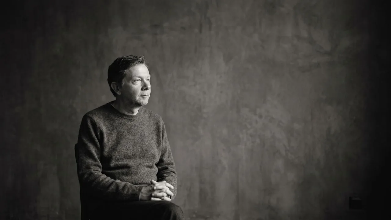 Eckhart Tolle in a beige cardigan with overlay text reading "There are TWO of YOU" in bold colored letters