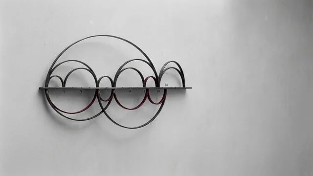 Abstract visualization of interconnected circles and curved lines in grayscale, depicting mathematical patterns and sequences