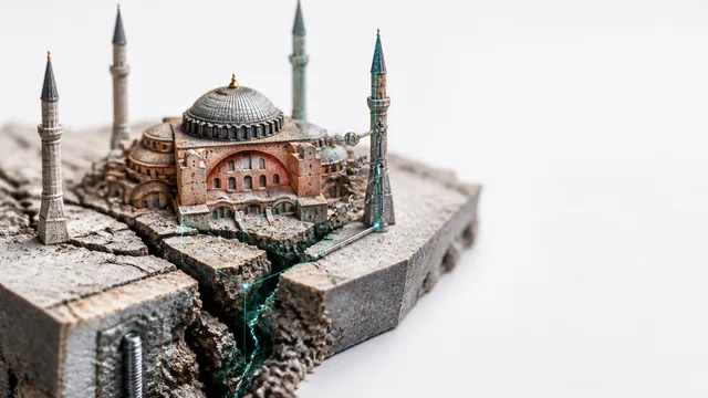 Historic domed mosque with red brick architecture and metal scaffolding covering its facade during restoration work
