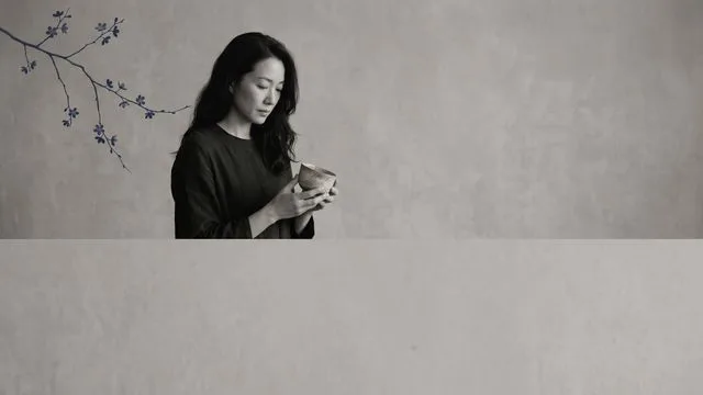 A partially obscured black and white portrait of a woman with the title "EMOTIONAL INVISIBILITY" displayed above against a…