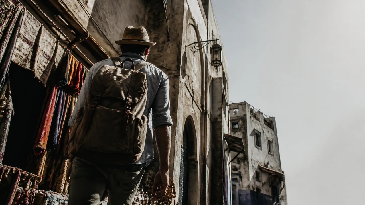 Man and child enjoying orange juice in a Mediterranean plaza with historic architecture and "LIVE LIKE A LOCAL" text overlay