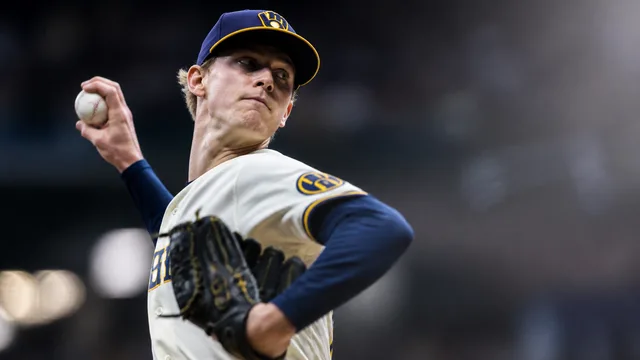 Milwaukee Brewers pitcher #32 adjusting his cap during a game, with text overlay listing names he is not
