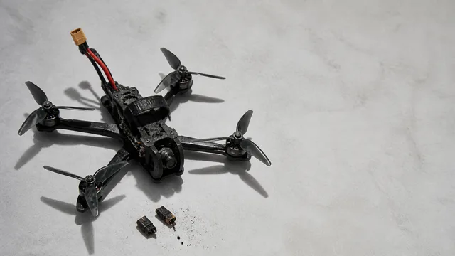 Blue racing drone surrounded by components under red LED lighting with "NOT A TUTORIAL" text overlay