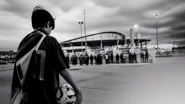 Hand holding a FIFA World Cup 2026 ticket priced at $22,316.90 with stadium seating chart visible in background
